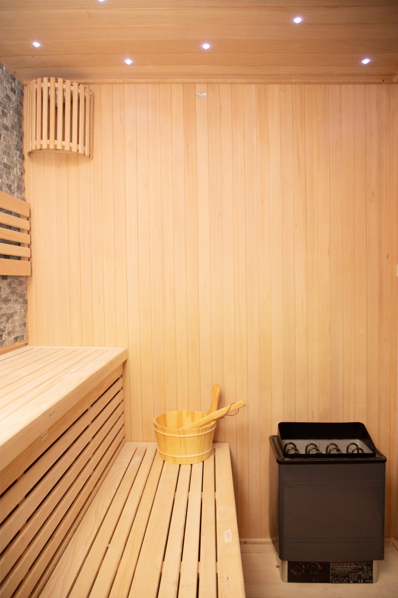 Nicebeam Canadian Hemlock sauna with benches, bucket, and heater.