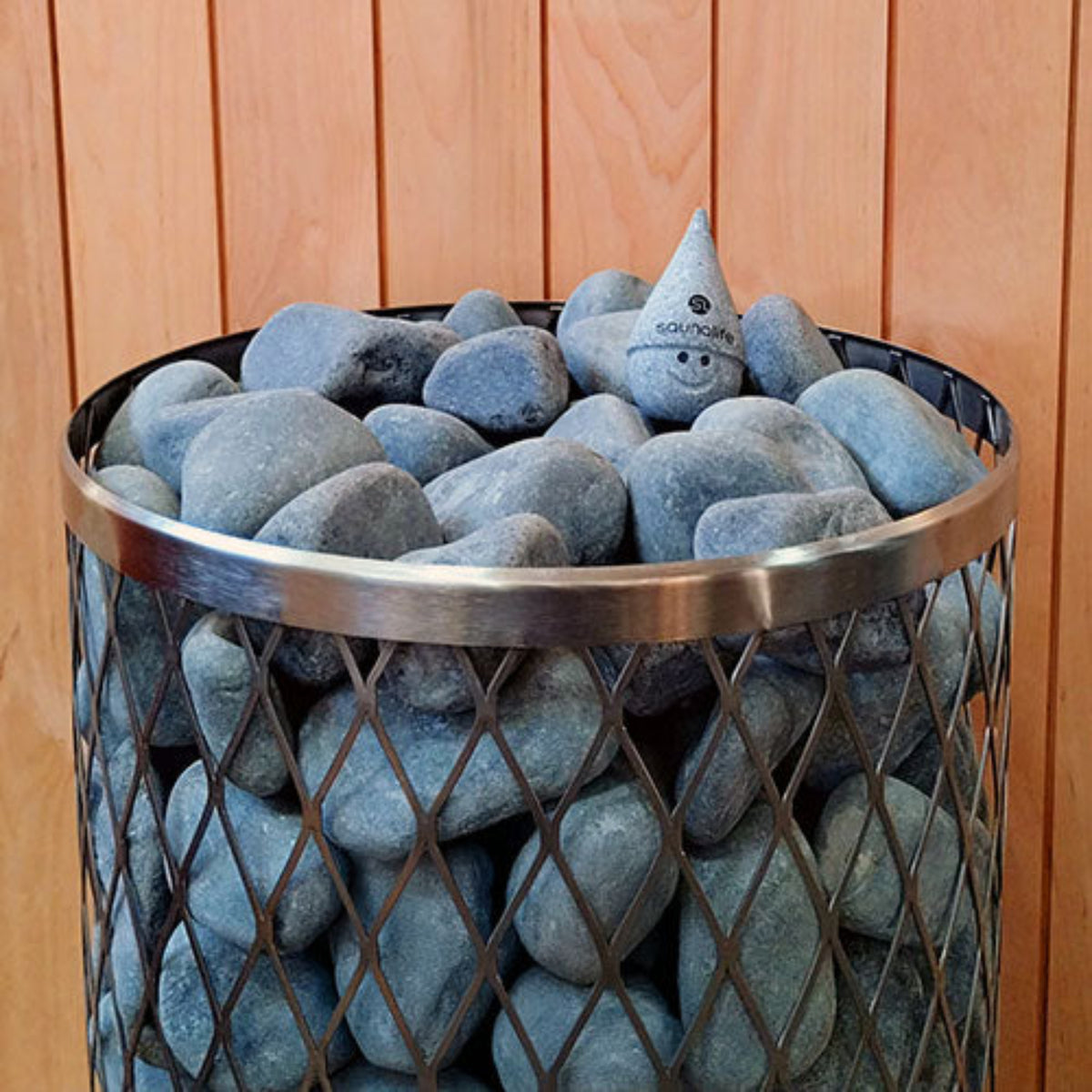Basket filled with blue gray stones against a wooden background with SaunaLife Stoney Sauna Gnome
