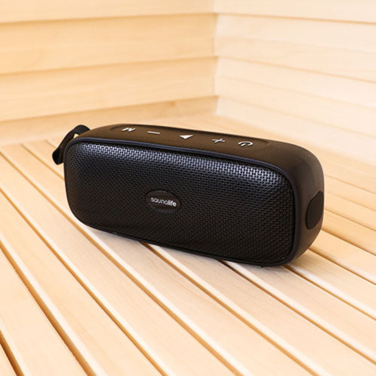 Black portable speaker on a wooden sauna bench