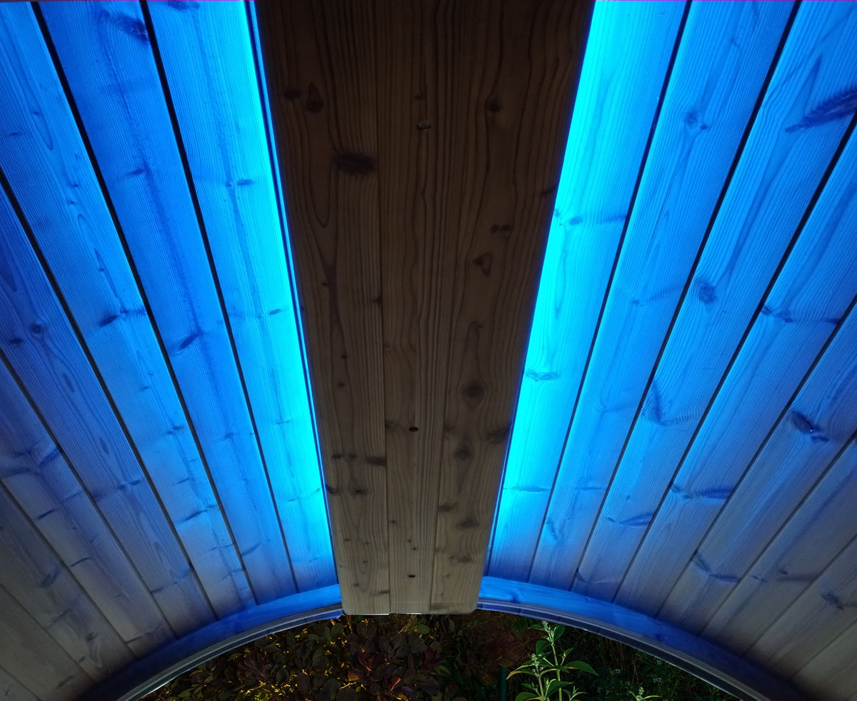 Wooden Sauna ceiling with blue LED lights on a circular structure.