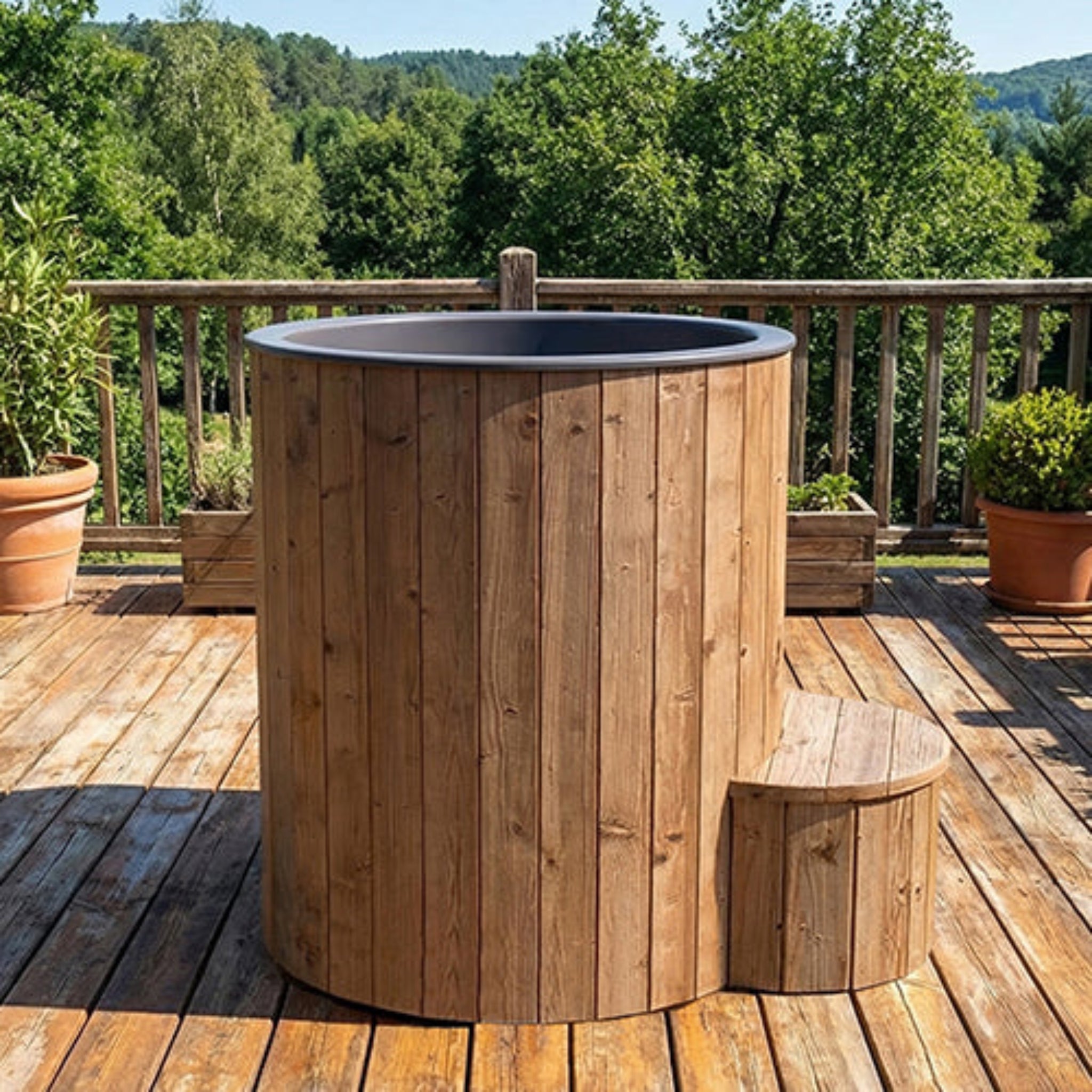 Saunalife S1N Wooden plunge tub with dark gray interior on a wooden deck with lush background.