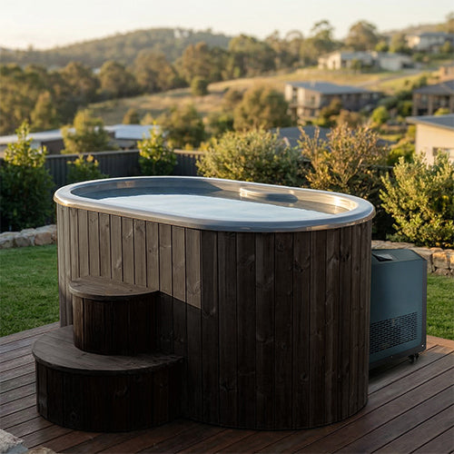 Hot and cold immersion tub with steps and chiller in a serene outdoor setting.