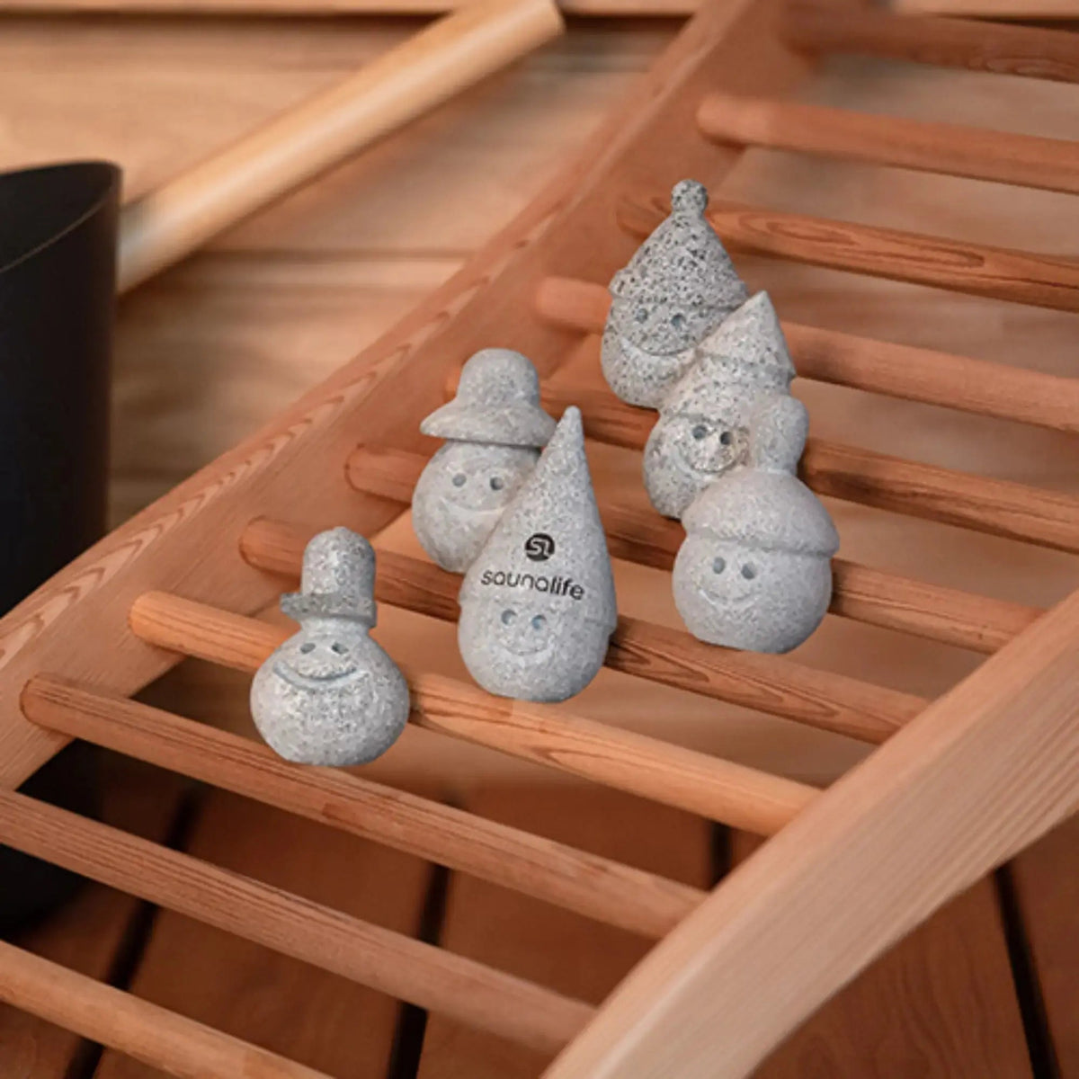 SaunaLife Stoney and Friends on a wooden backrest in a sauna