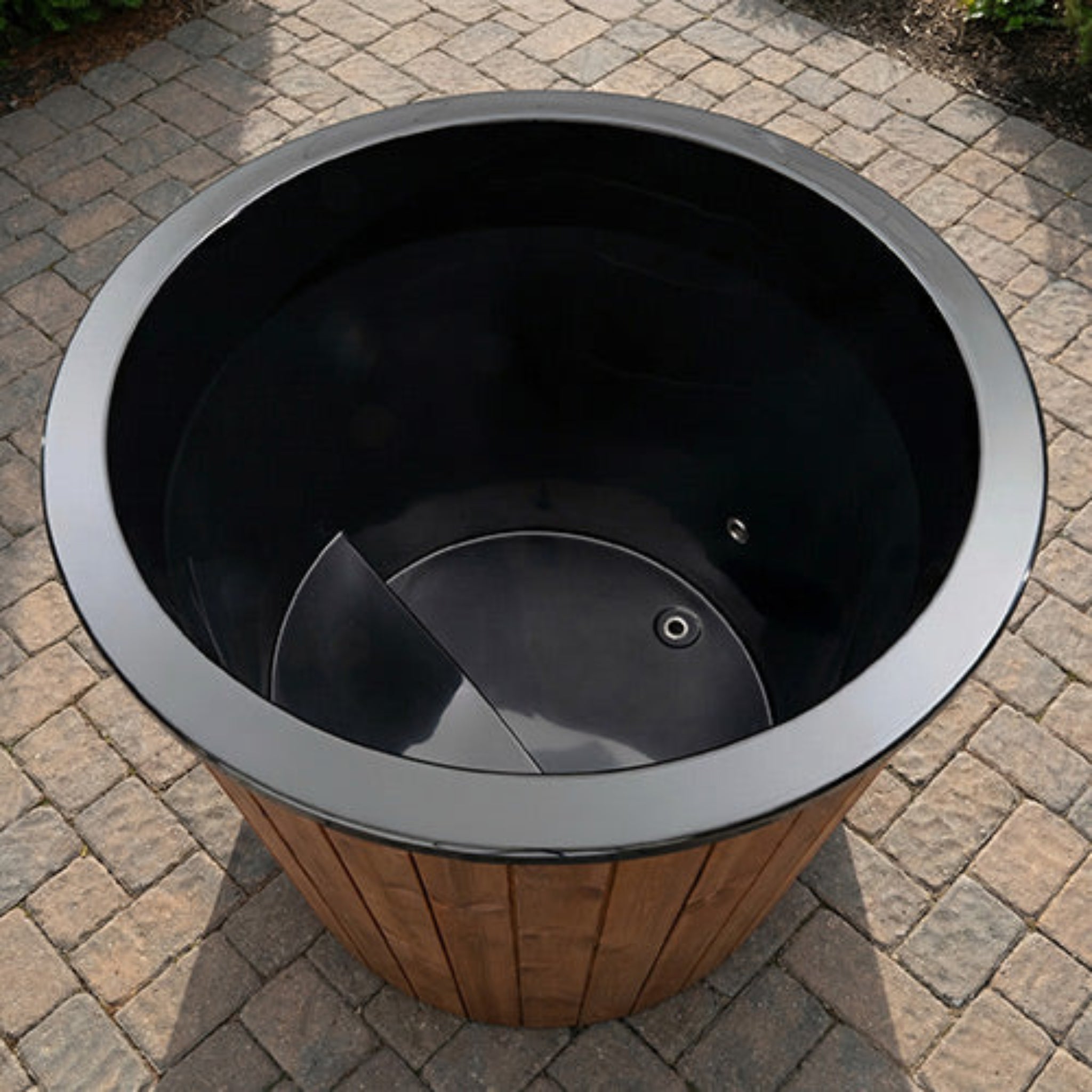interior looking down inside the Saunalife S1N immersion tub on a brick outdoor pation