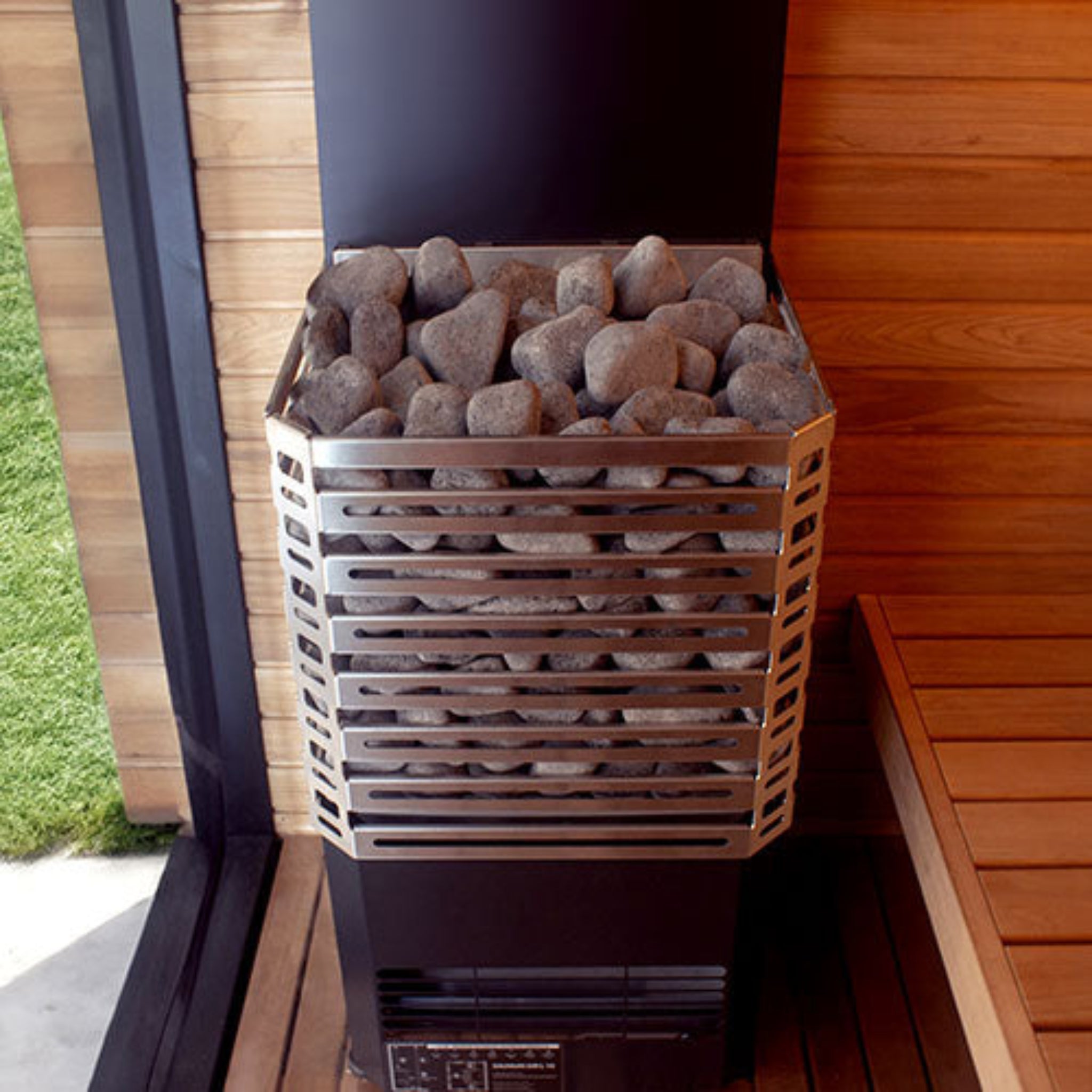 front view of Saunum Air sauna heater with stones installed inside a sauna