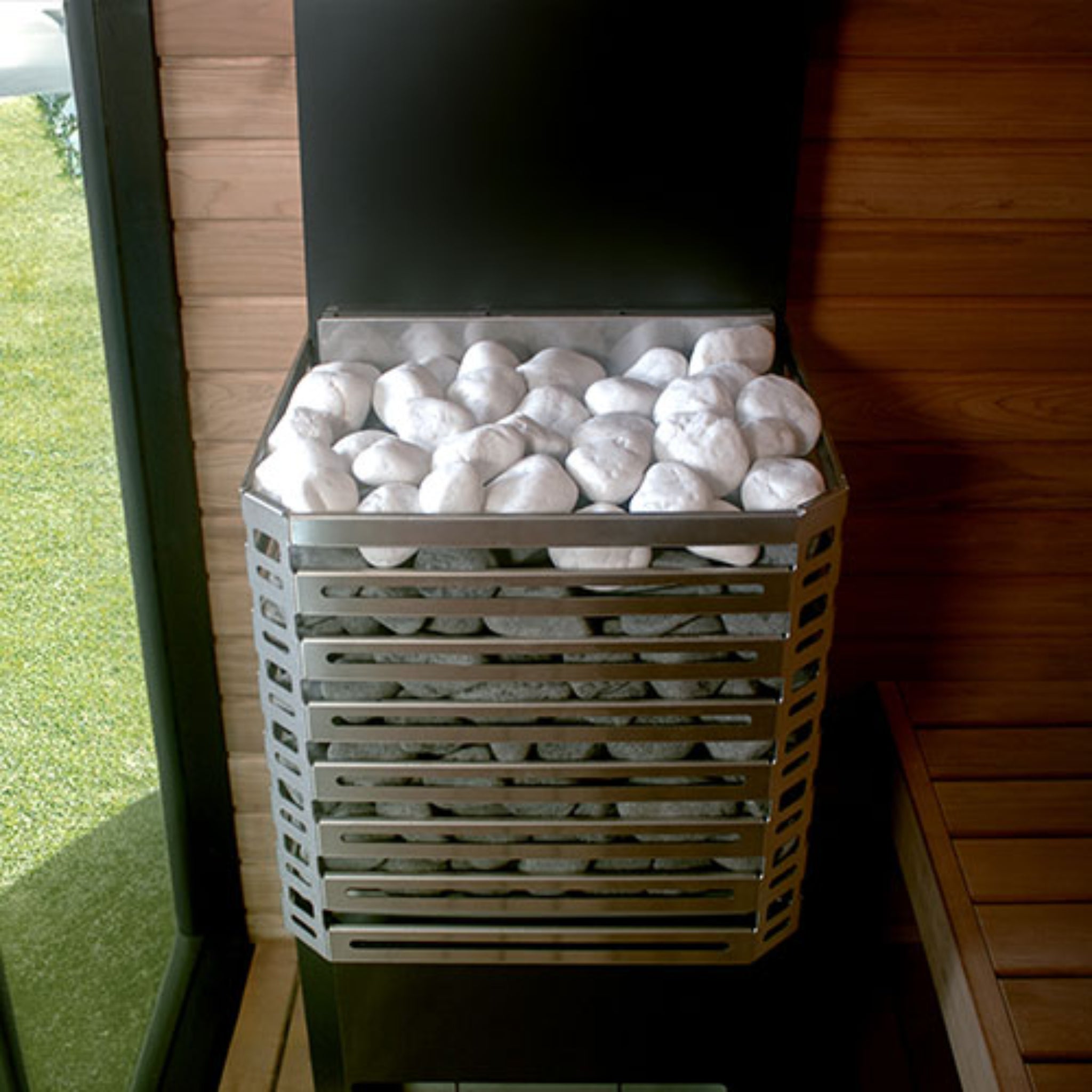 front view of Saunum Air sauna heater with white stones inside asauna