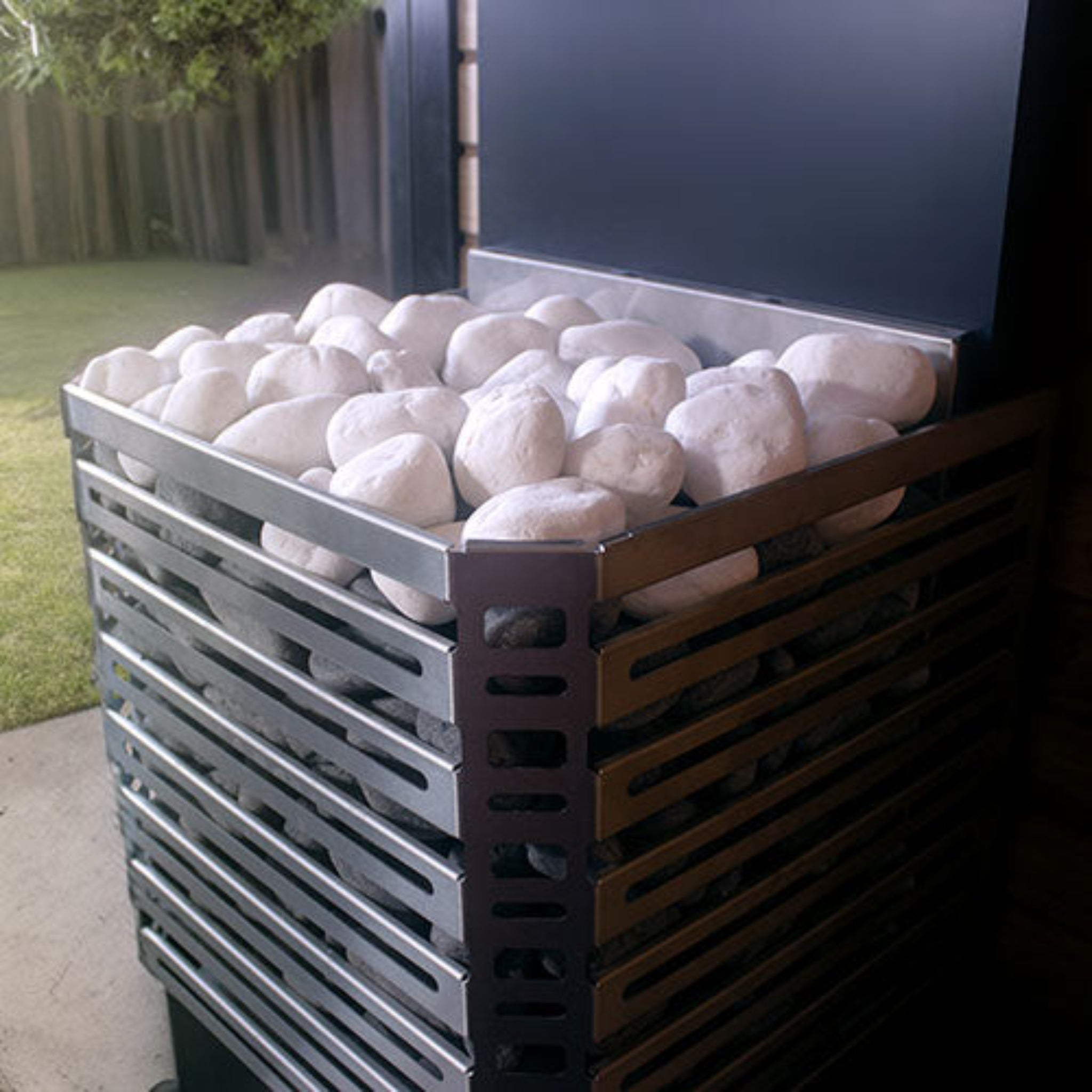 white stones inside the Saunum Air sauna heater inside a sauna