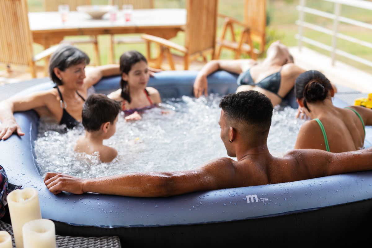 Group of people relaxing in an inflatable hot tub outdoors.
