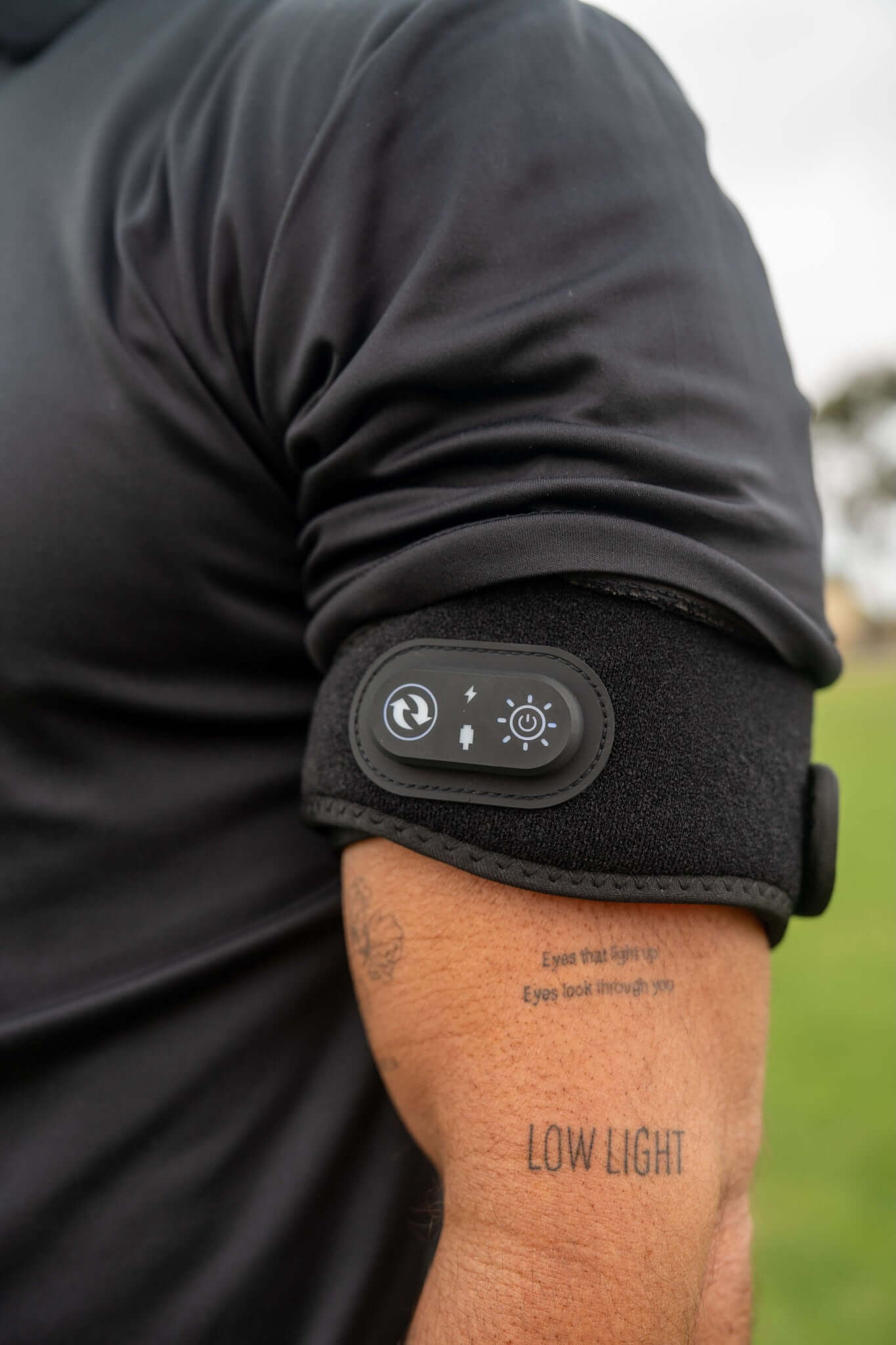 Person wearing The wrap on his arm showing  the control buttons on a blurred outdoor background