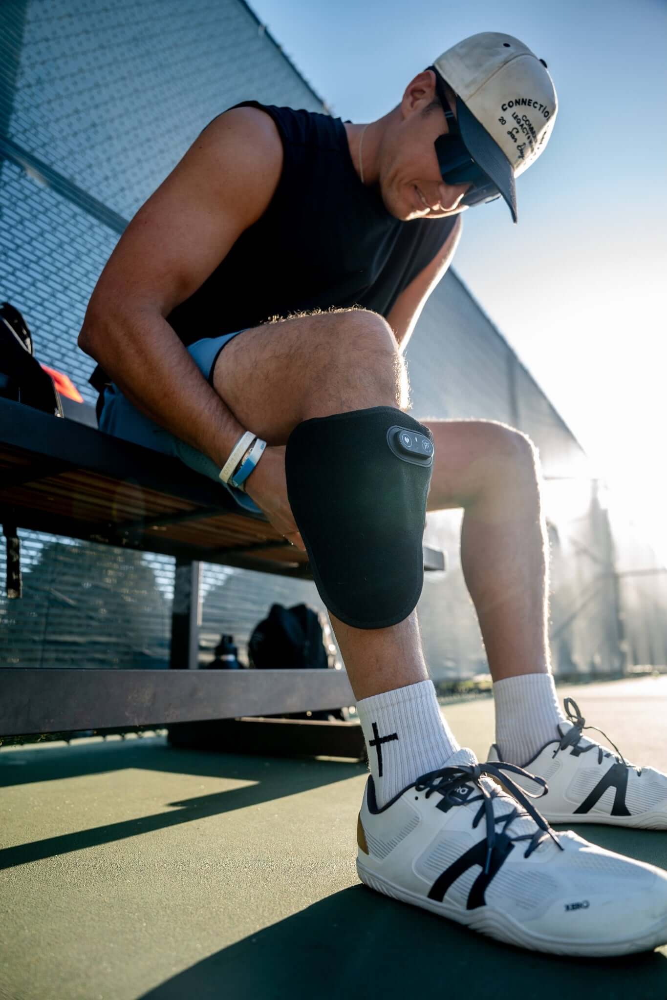 a person sitting on a bench with the Wrap on his leg