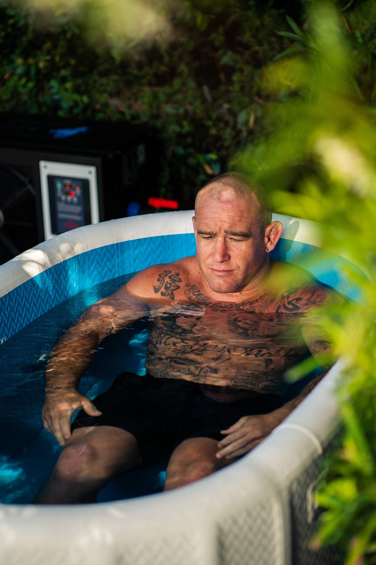 Person using a RevX inflatable cold plunge outdoors
