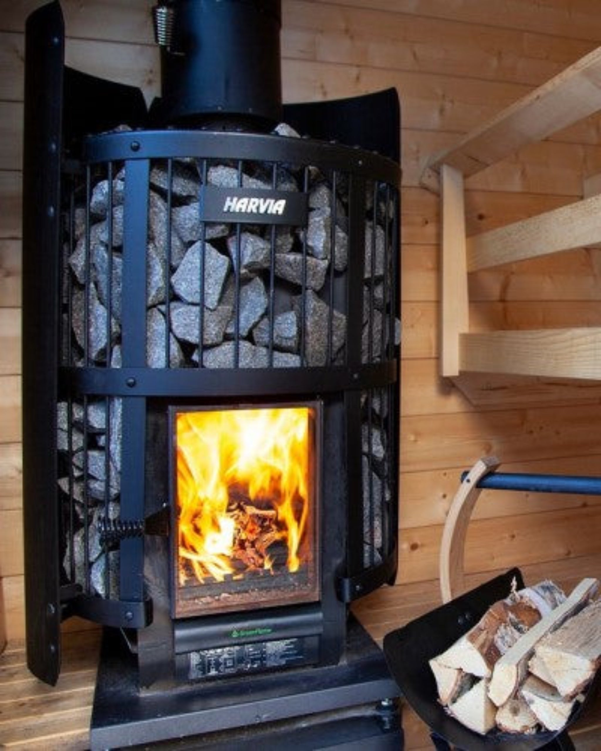 Harvia Legend 240 GreenFlame sauna stove installed in a traditional wood sauna room
