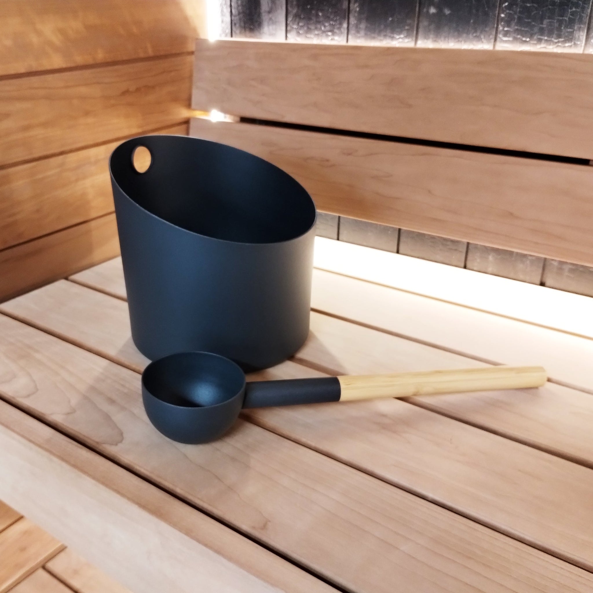  KOLO black sauna bucket and ladle — lifestyle view on sauna bench