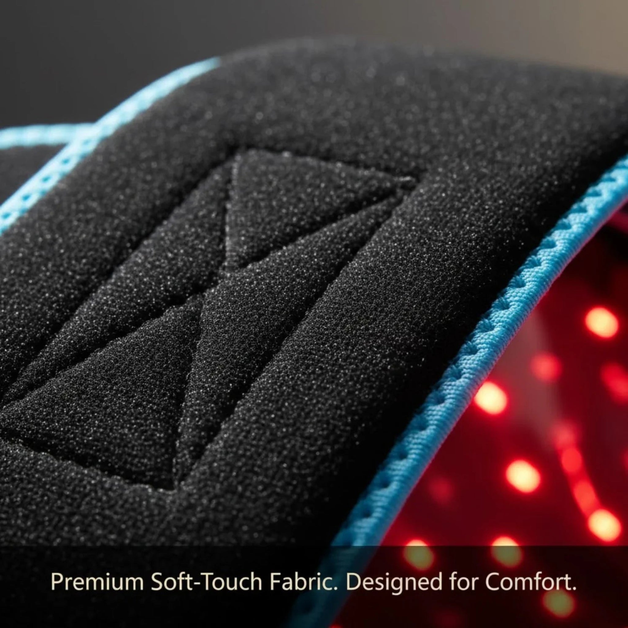 Close-up of a black textured Nicebeam red light belt with blue edges and red light interior.