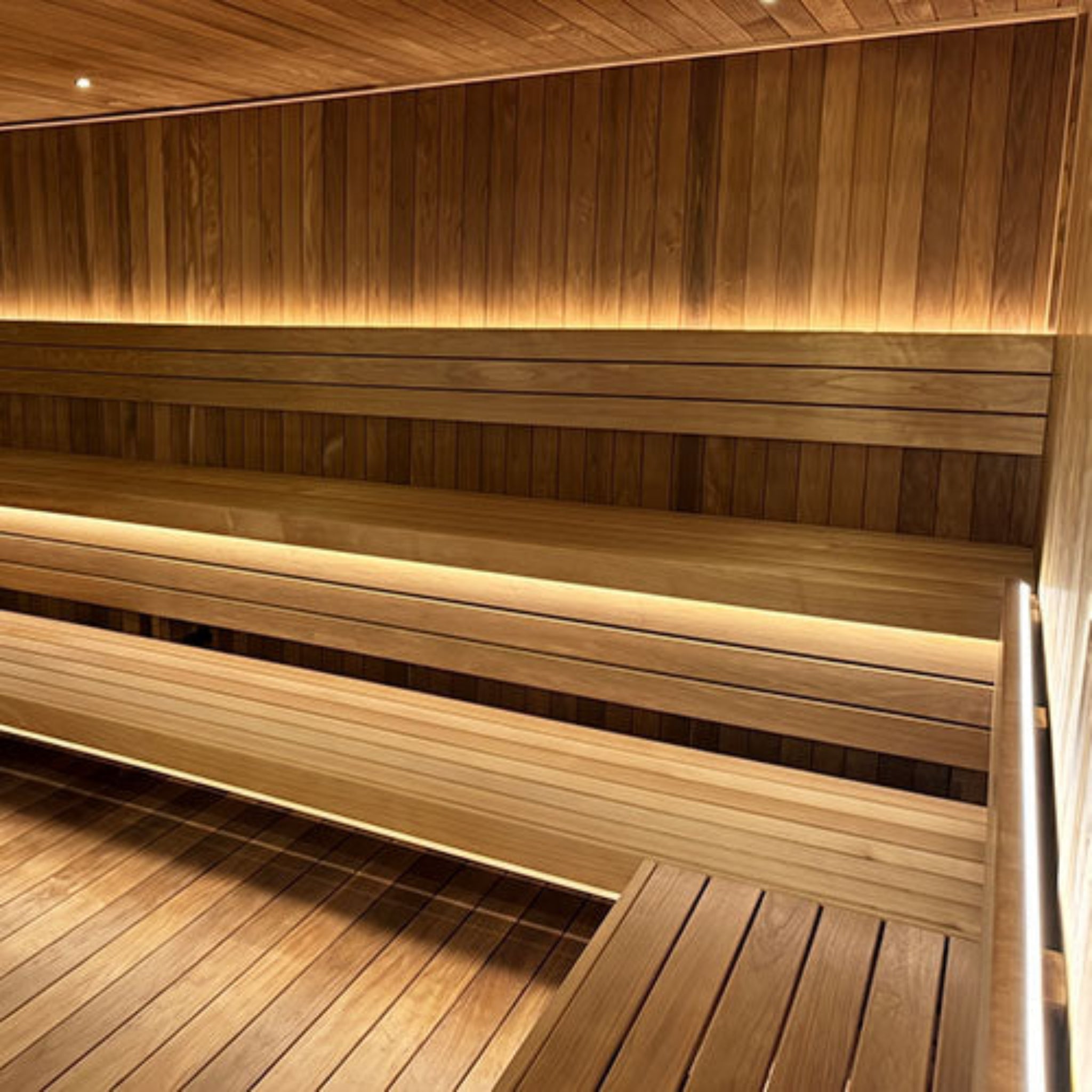 a wooden sauna bench inside a sauna showing Prosaunas led light
