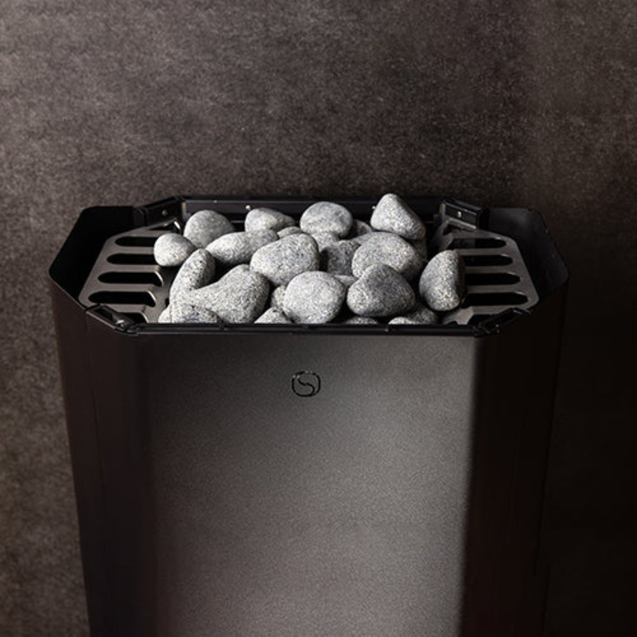 Black saunum air perfect sauna heater with stones on a dark background